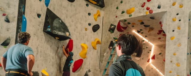 climbing gym interior with climbers and route setter — Aesthetic Climbing Gym, from its own website