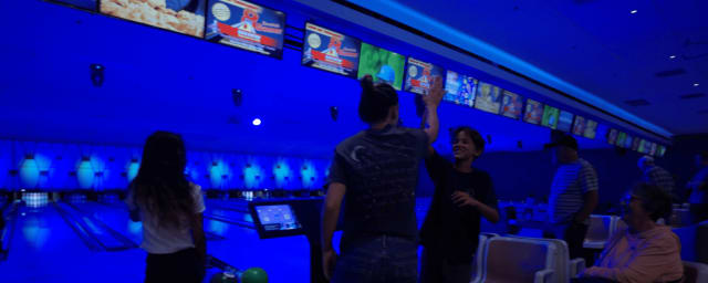 bowling alley lanes with pins and scoring screens visible — Saddleback Lanes, from its own website
