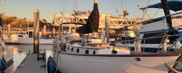sailboat charter vessel at marina dock — Pura Vida Sailing Charters, from its own website