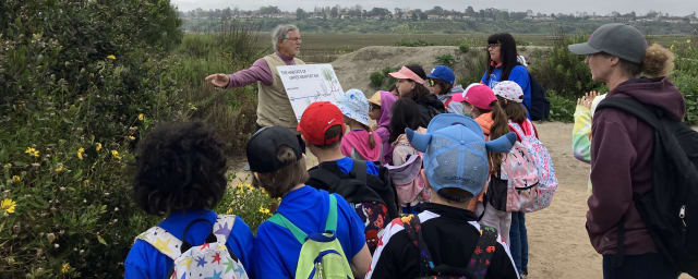 guided nature walk group at wetland habitat — Peter and Mary Muth Interpretive Center, from its own website