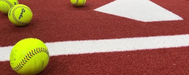 venue photo - softball practice area with balls on home plat — Slo Swing Sports, from its own website