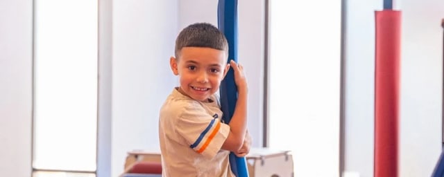child on zipline swing equipment at venue — We Rock The Spectrum - Clovis, from its own website