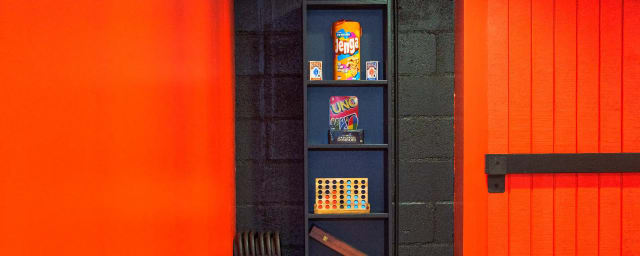 venue interior with escape room games/props on shelf — Hypnotic Escape Rooms, from its own website