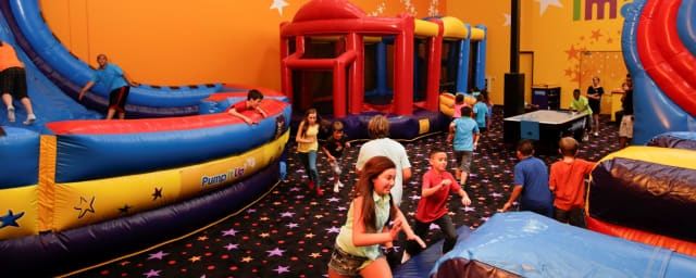 venue interior with inflatable attractions — Pump It Up Van Nuys Kids Birthdays and More, from its own website