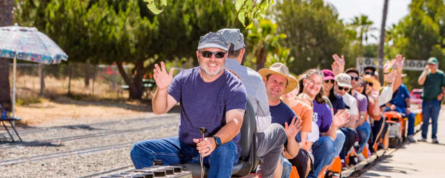 riders on miniature train at model engineers venue — Orange County Model Engineers, from its own website