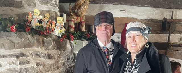 posed group at venue fireplace — Lower Swedish Cabin, from its own website
