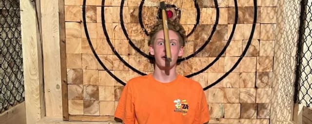 posed portrait in activity setting — Carried Away Axe Throwing, Rage Room & Splatter Room, from its own website