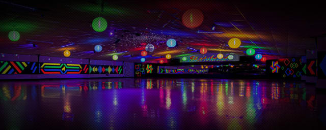 empty rink floor under colorful hanging orbs, disco ball, neon murals on walls, reflections on floor — Skatelands of America, from its own website