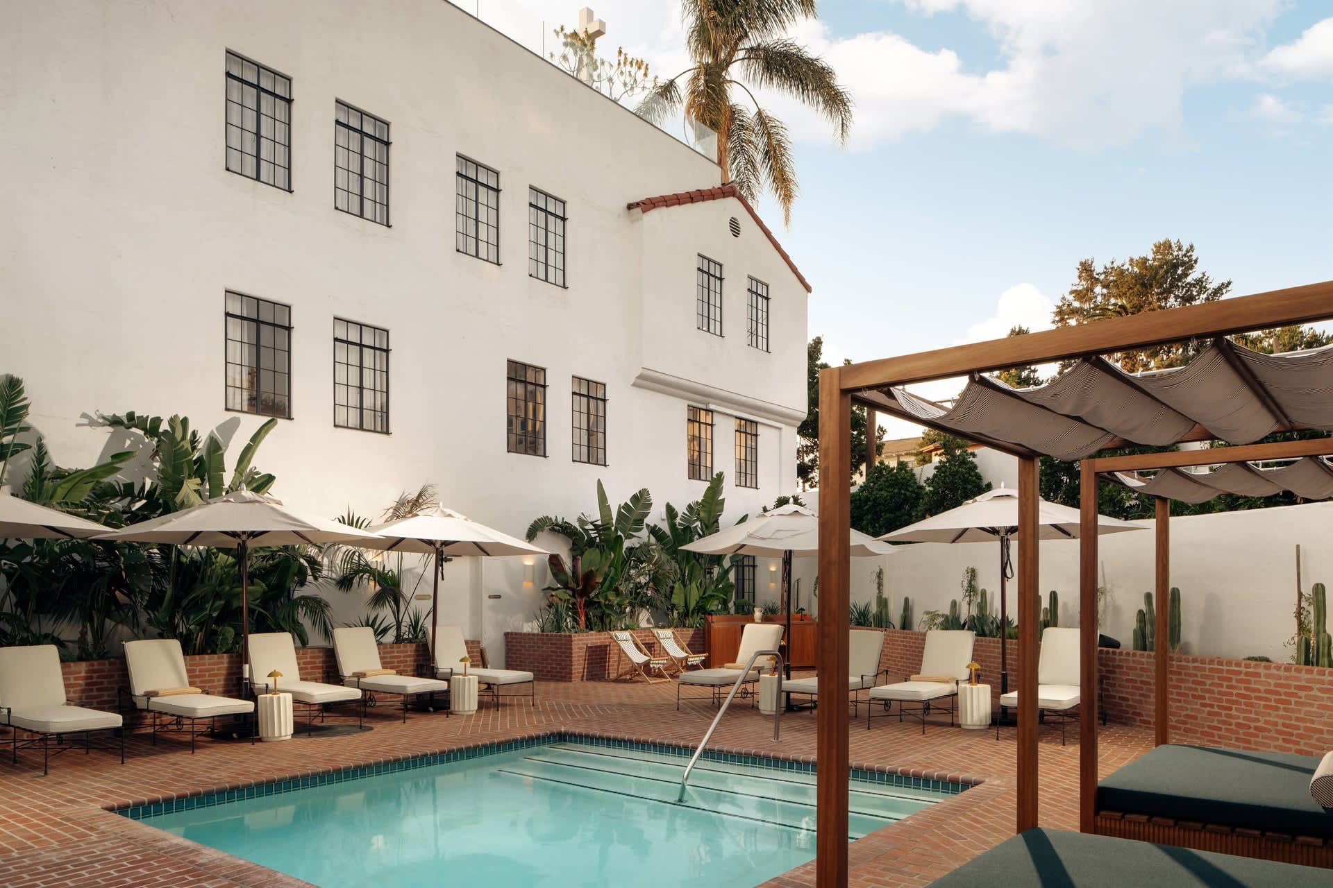 Hotel Lucile pool in Silver Lake, loungers, umbrellas and the white facade of the former church