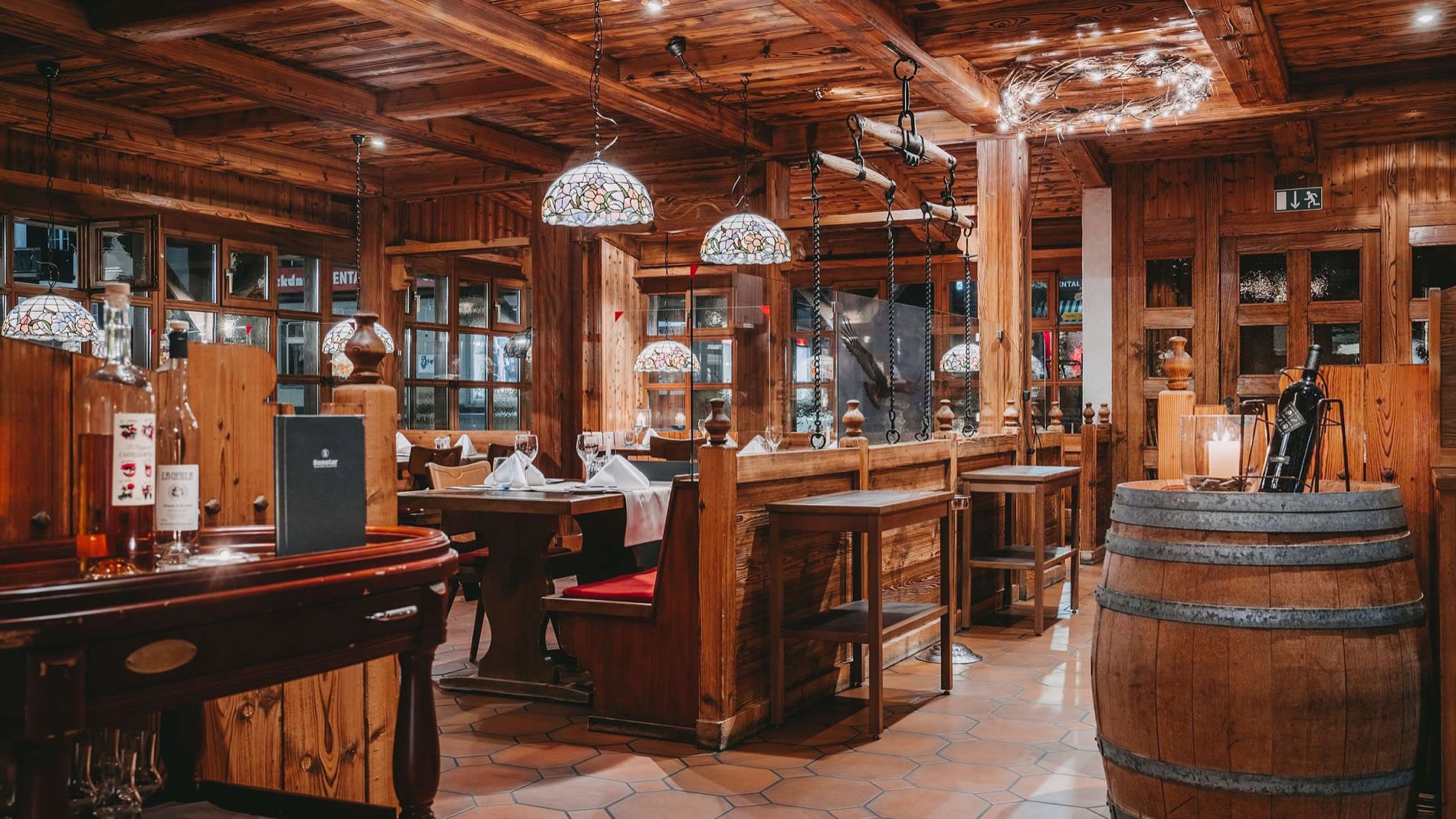 Salle de l'Adlerstube au Sunstar Grindelwald, boiseries, tonneau et lampes Tiffany