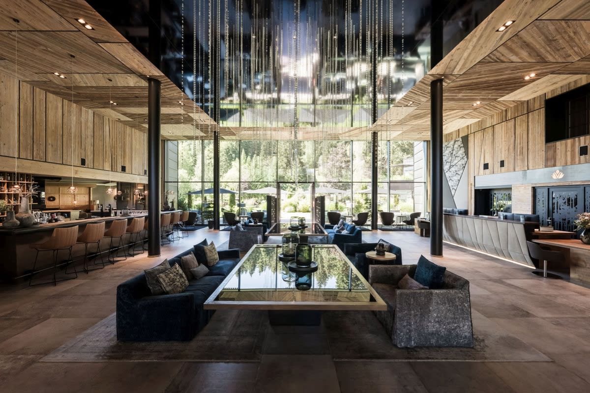 Lobby bar at the Viktoria Alpine Hideaway, high wooden ceilings, pendant lights and floor-to-ceiling windows