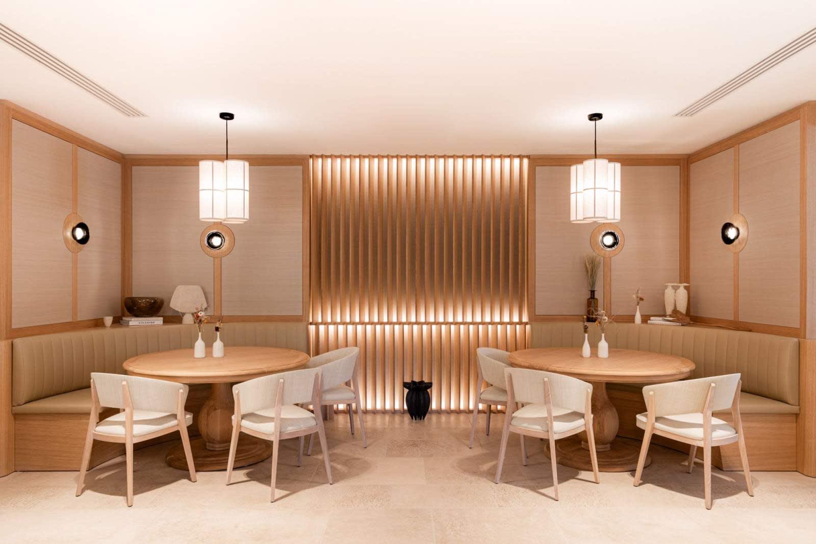 Dining room of Le Feuillée restaurant at Le Couvent des Minimes in Mane, with light wood decor and pendant lights