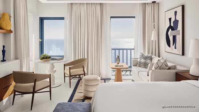 Room at Four Seasons Mykonos with floor-to-ceiling windows looking out to sea