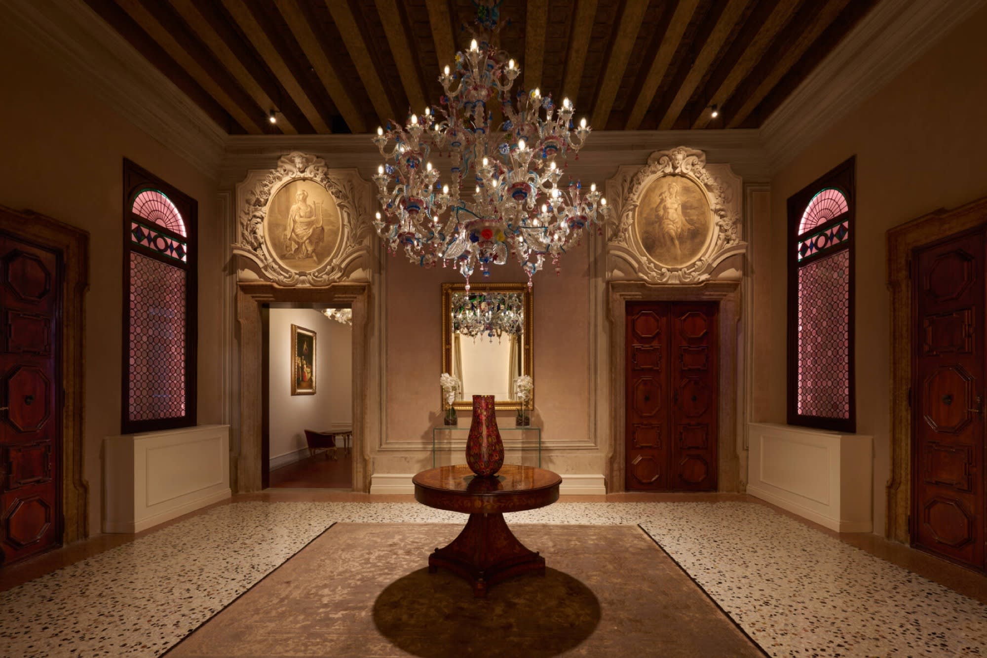 A corridor of the Palazzo Giovanelli's piano nobile, with a Murano chandelier and lacquered doors
