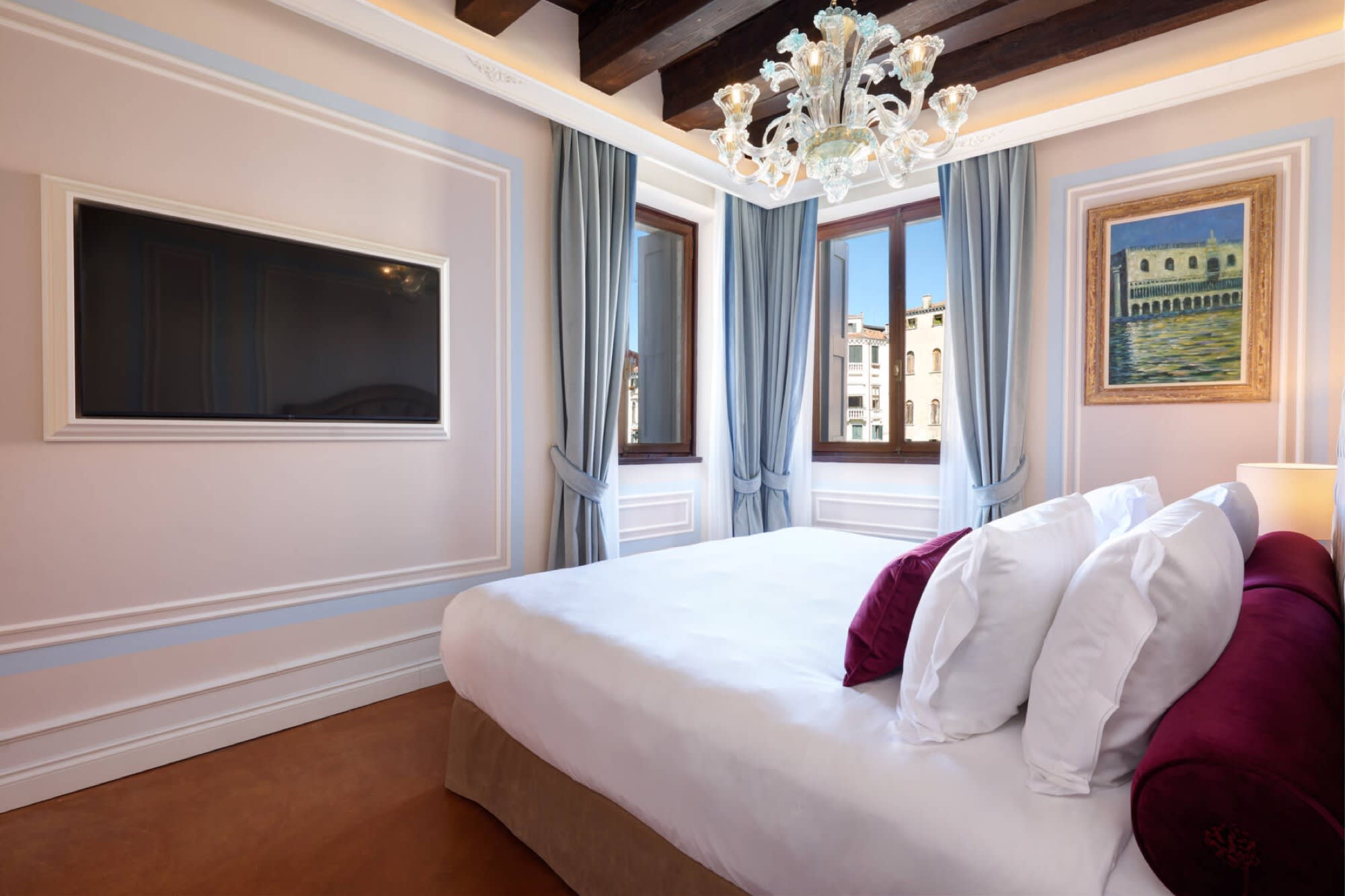 A suite at Palazzo Giovanelli with a Murano chandelier and a view of the Grand Canal