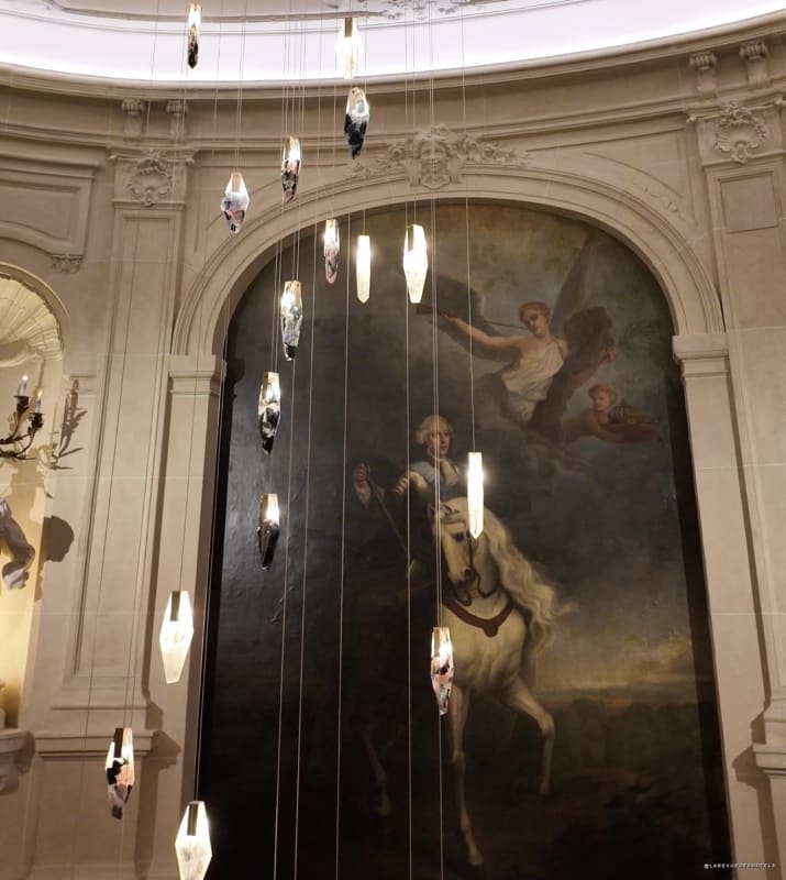 Set design for the Peet Dullaert show: crystal pendants suspended in front of a classic equestrian painting