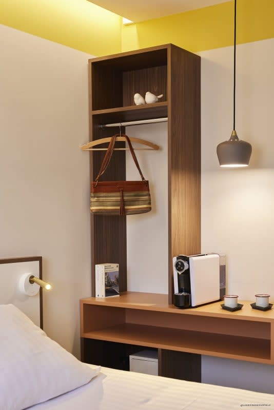 Desk area and coffee machine in a room at Hôtel du Pin