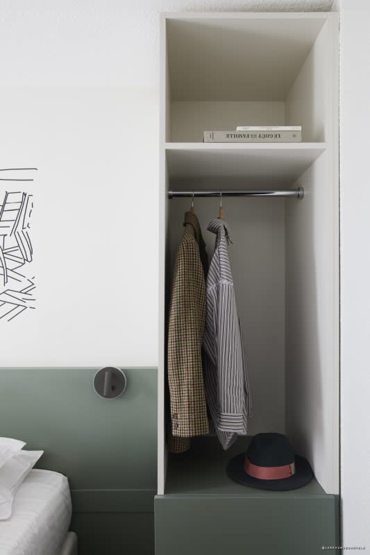 Neat storage and wardrobe in a room at Hôtel Isidore