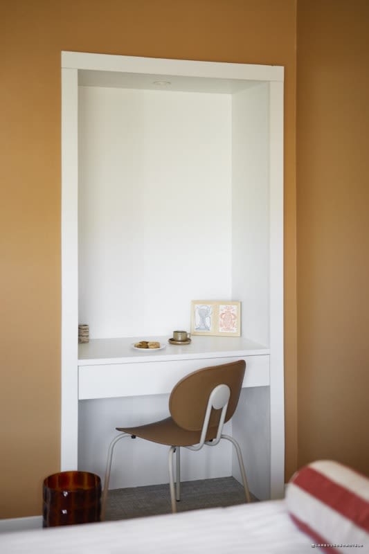 Desk area in terracotta tones at Hôtel Abrial