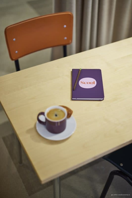 Notebook and coffee on a table in a Scool space