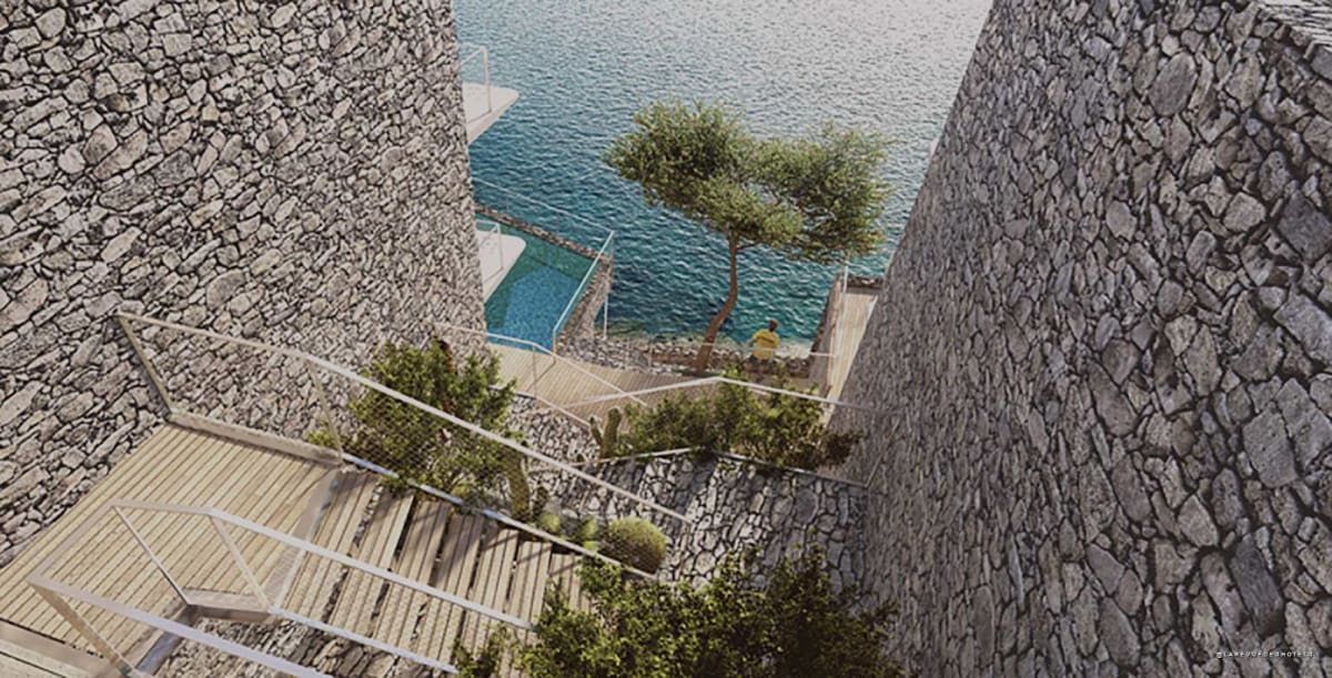 Wooden terraces and olive tree among stone walls at Hôtel Les Roches