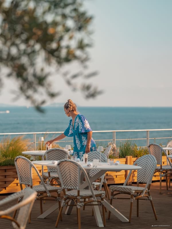 Table set on the terrace of Hôtel Les Roches at sunset