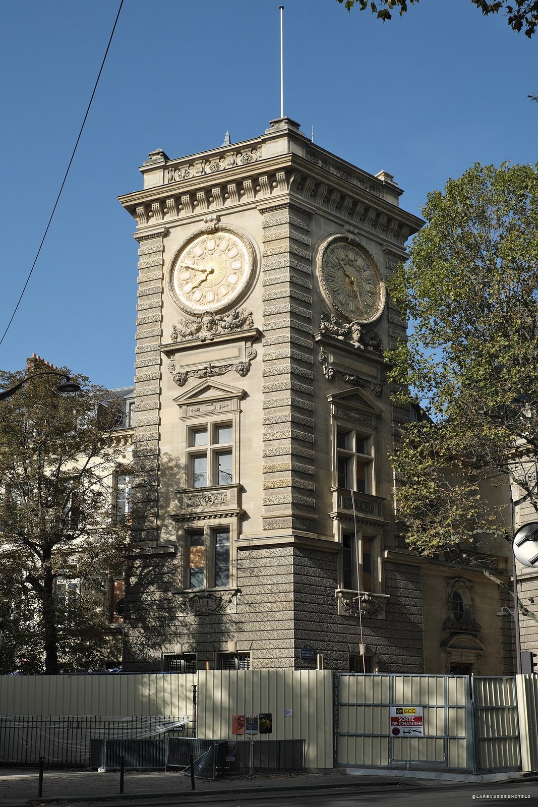 The clock tower of the Îlot Saint-Germain, in Paris, behind the construction hoardings