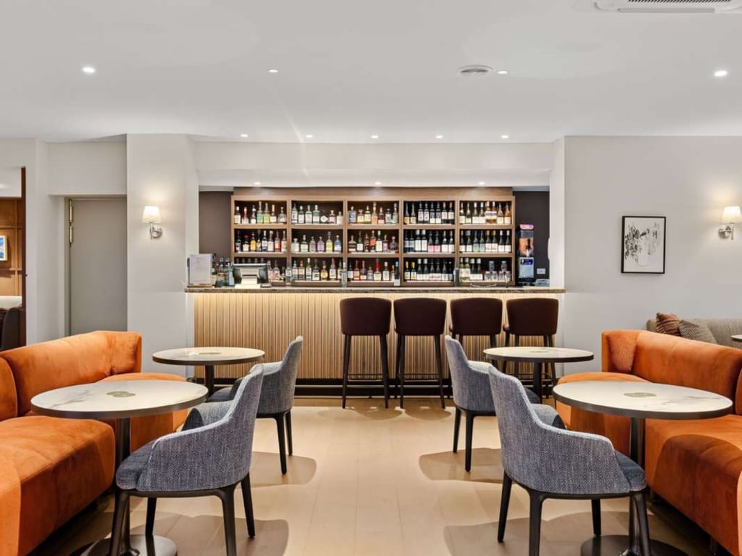 Lounge bar at Peppers Clear Mountain, orange banquettes and stools