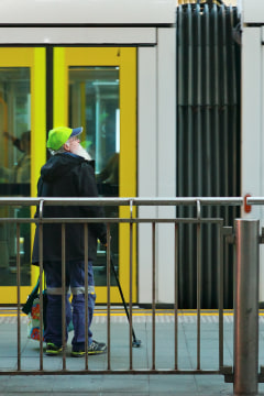 old man waiting for a tram