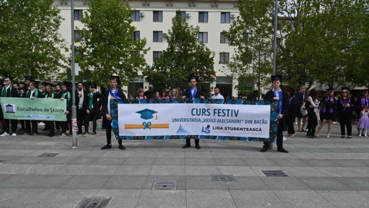 Absolvenți universitate defilând în Bacău în zi de festivitate