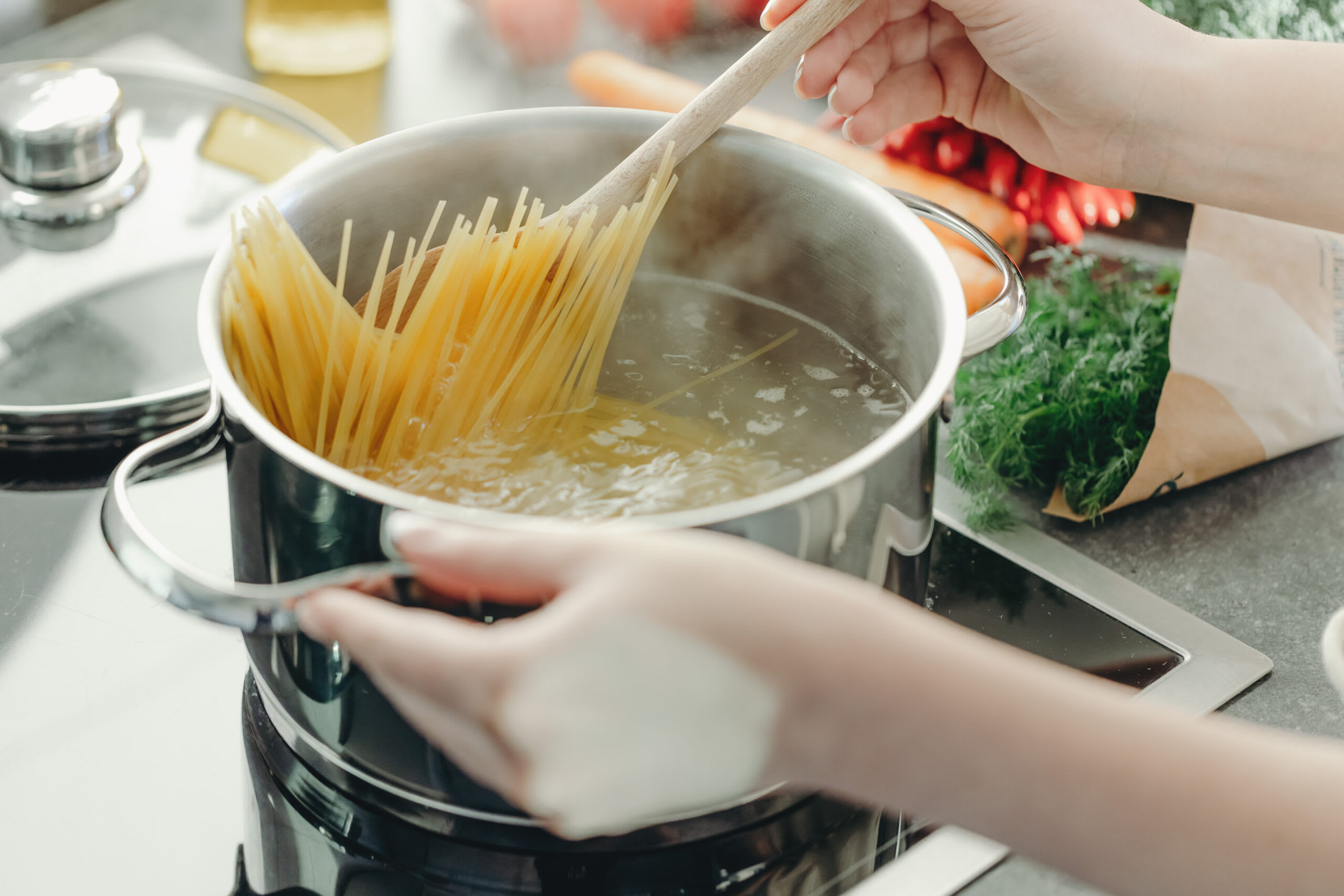 Bucătar în bucătărie preparând paste italiene