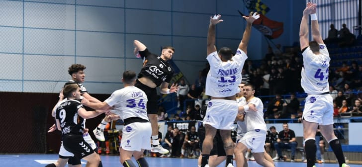 Jucători de handbal în acțiune pe terenul Politehnica Timișoara