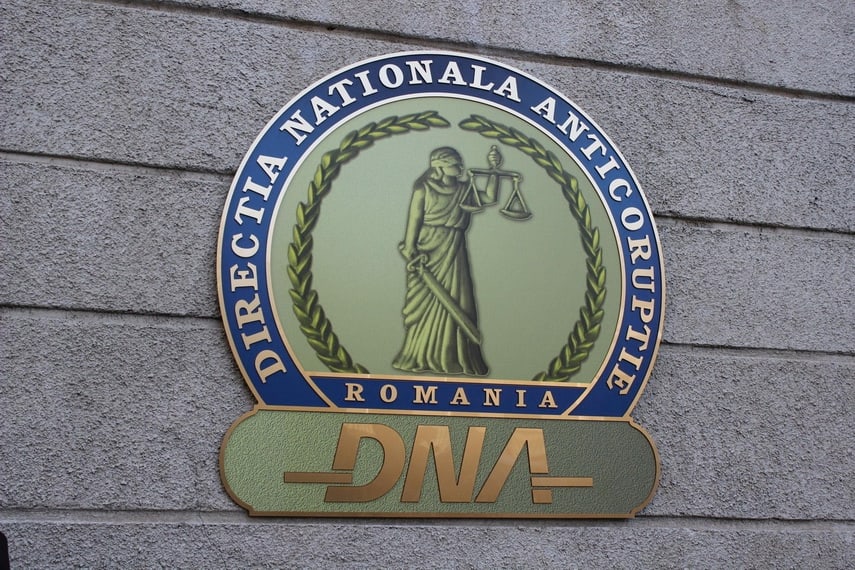 Romanian police officer arresting suspect in corruption case