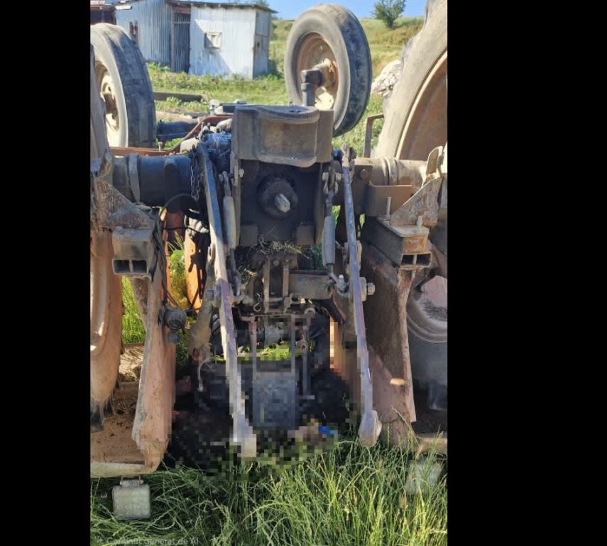 Pompieri scoțând bărbatul de sub tractorul răsturnat în Flămânzi