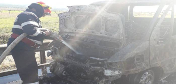 Pompieri stingând incendiu la autoutilitară pe autostrada