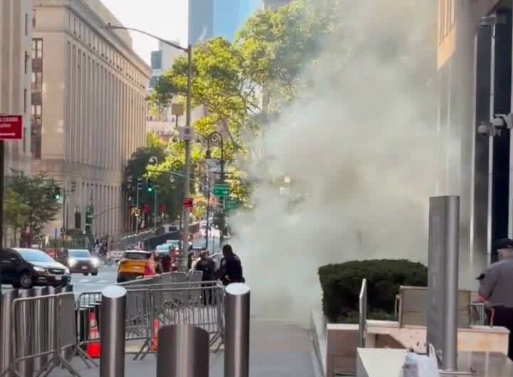 FBI agents arresting suspect in front of federal building in New York