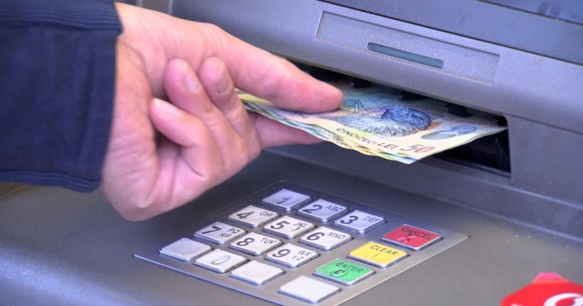Romanian tourist withdrawing money from ATM abroad