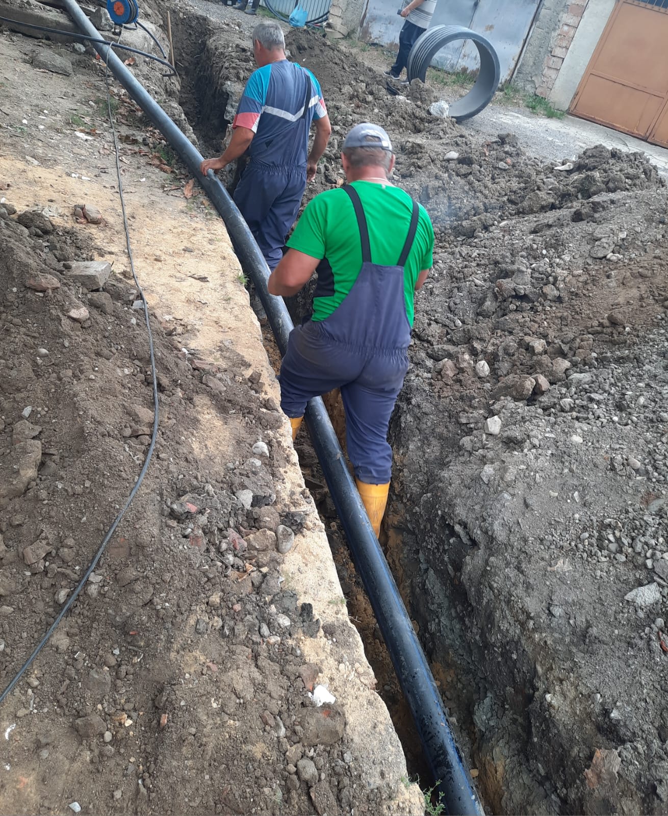 Conductă de apă nouă în șantier, muncitori, utilaje, peisaj urban Zalău
