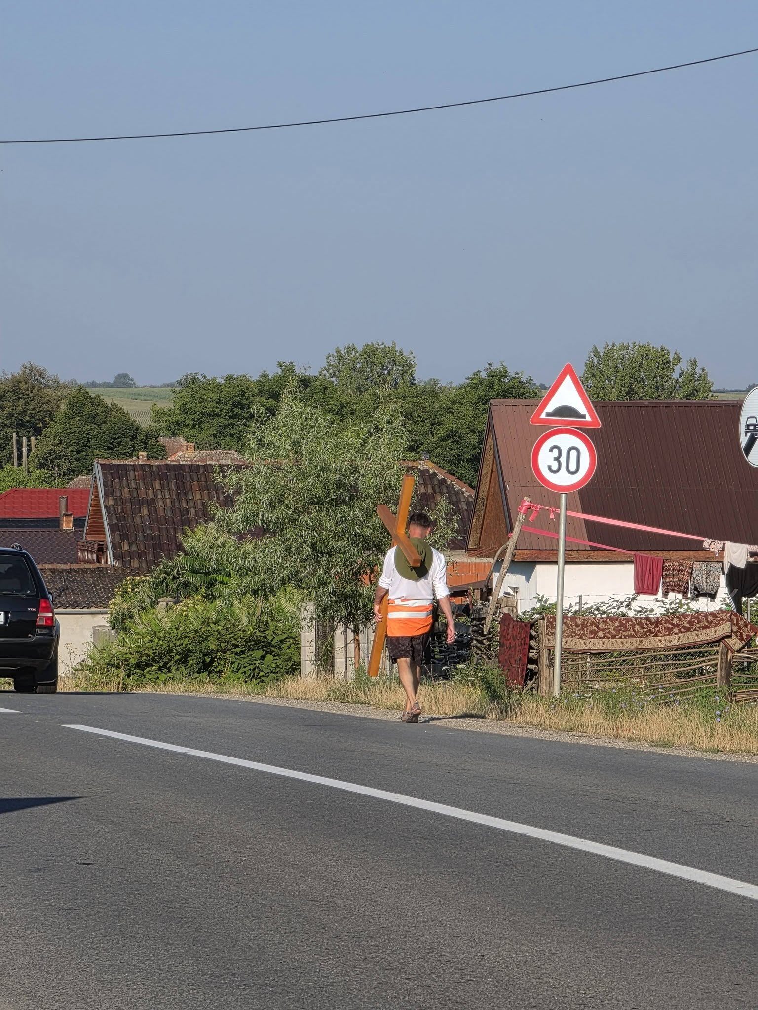 Om cu cruce în spate mergând pe drum, simbol al luptei personale Om cu cruce în spate mergând pe drum, simbol al luptei personale