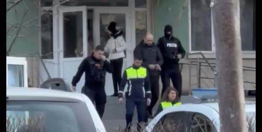 Romanian police officer arresting suspect in street Romanian police officer arresting suspect in street