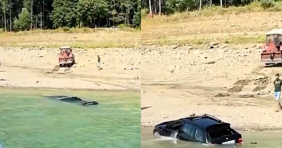 Mașină scufundată în Lacul Bicaz fiind trasă cu tractorul Mașină scufundată în Lacul Bicaz fiind trasă cu tractorul