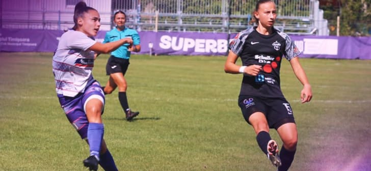 Jucătoare de fotbal în acțiune pe terenul de joc Jucătoare de fotbal în acțiune pe terenul de joc