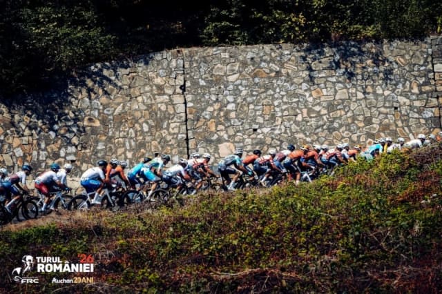 cicliști în cursă pe traseu montan, peisaj de munte