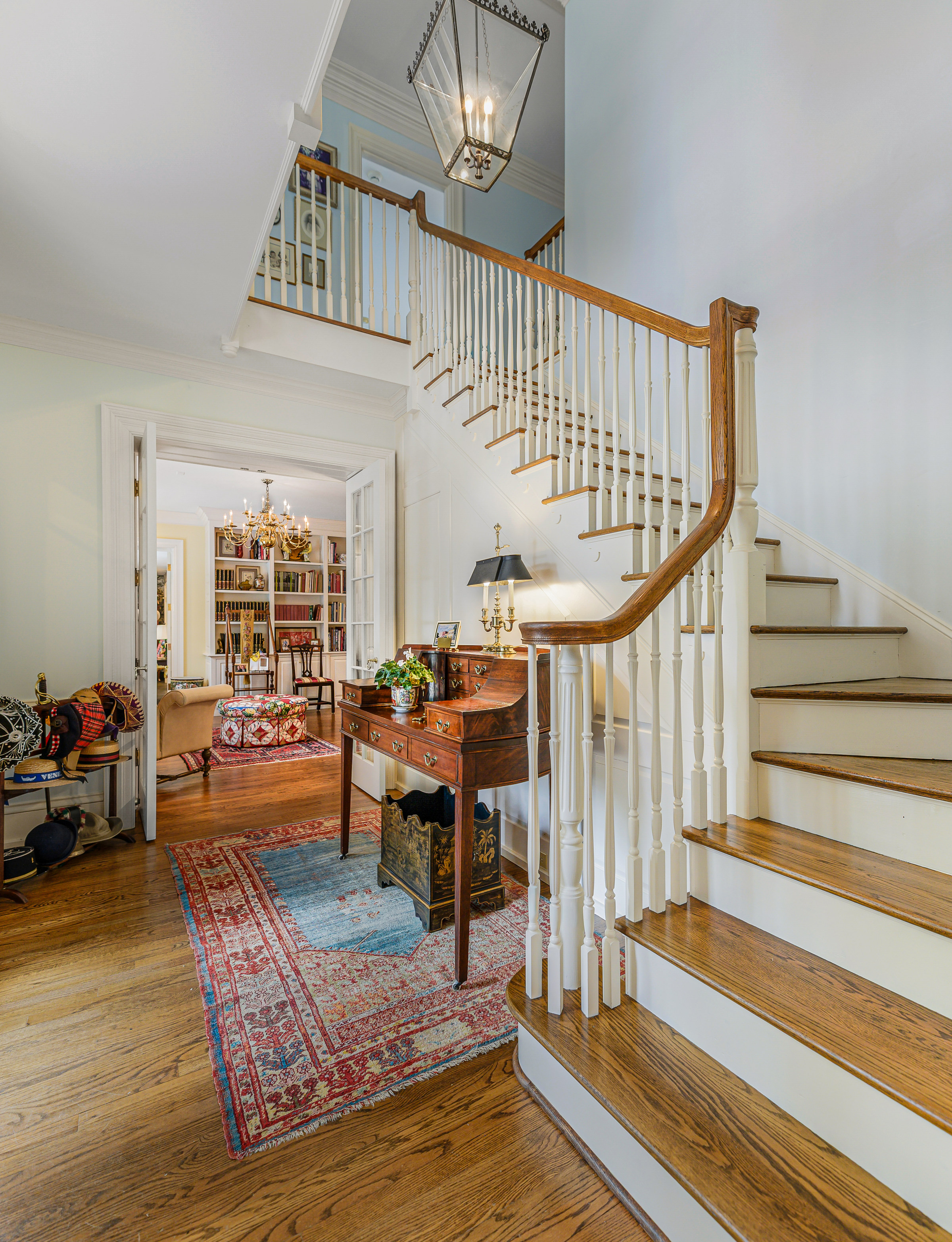 The staircase, the library through the door beyond