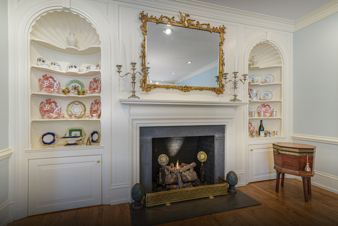 The original 1916 frontispiece, fire going, the shell cabinets flanking it