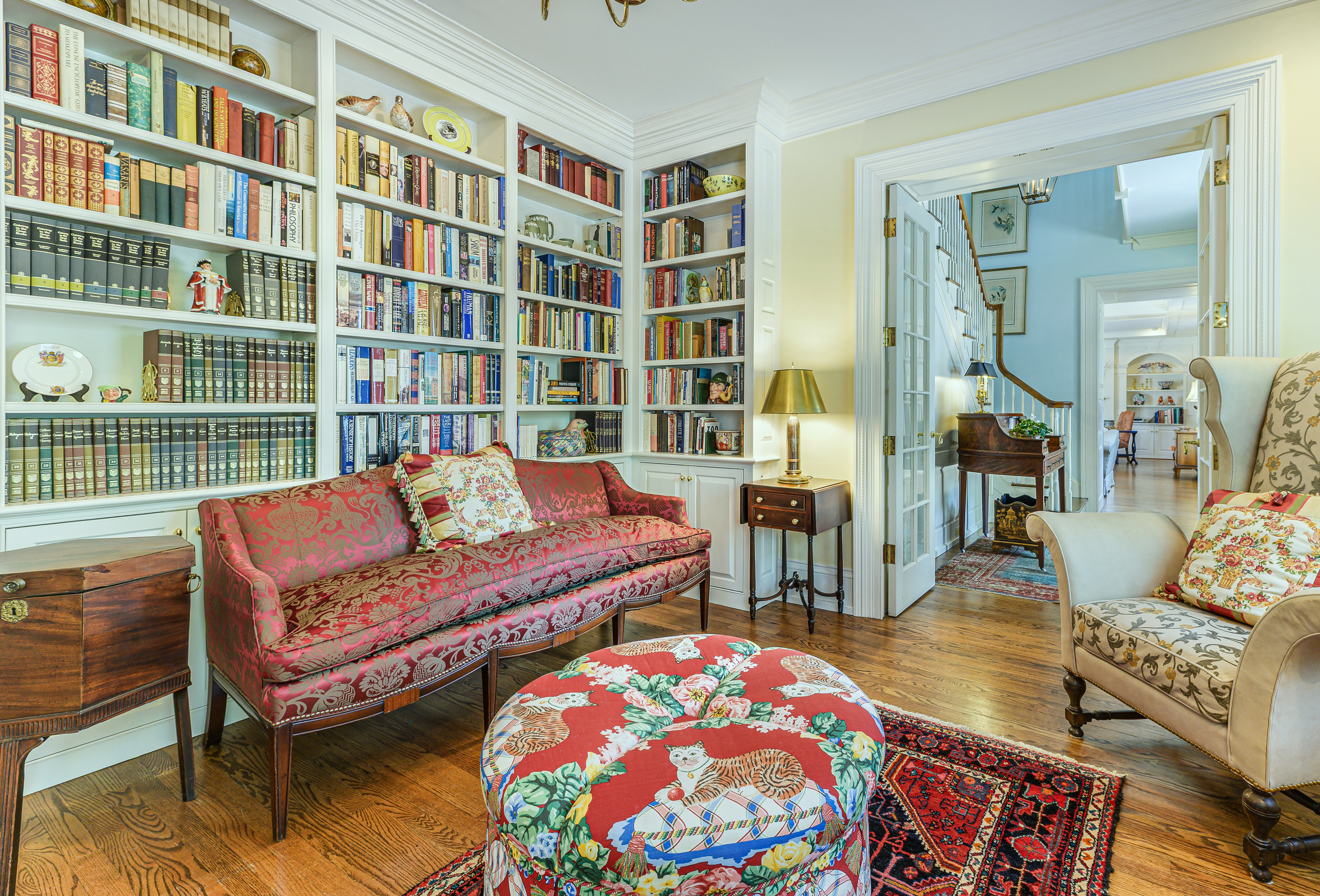The library, shelved to the ceiling on three walls