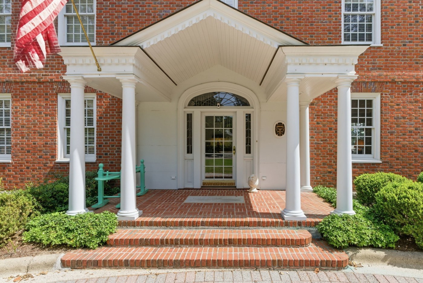 The centered portico and fanlit door