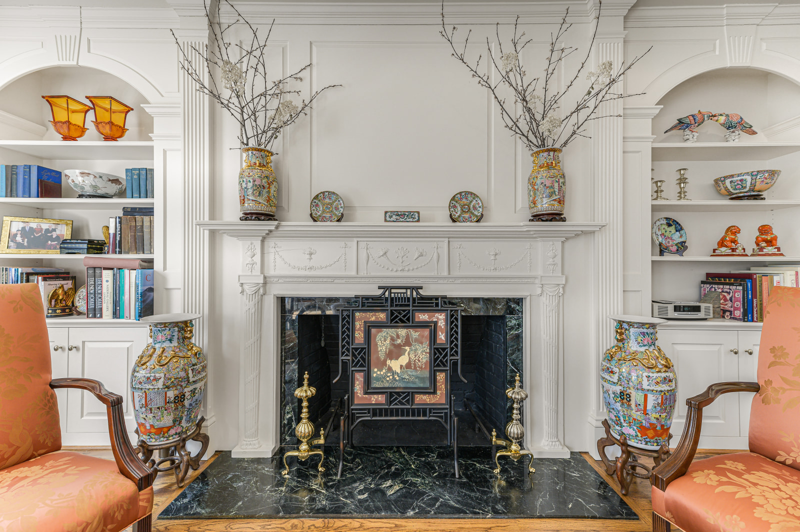 The Federal carved mantel over dark marble, the far end of the drawing room