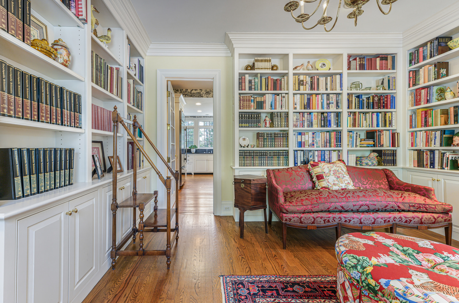The library, shelved to the ceiling on three walls