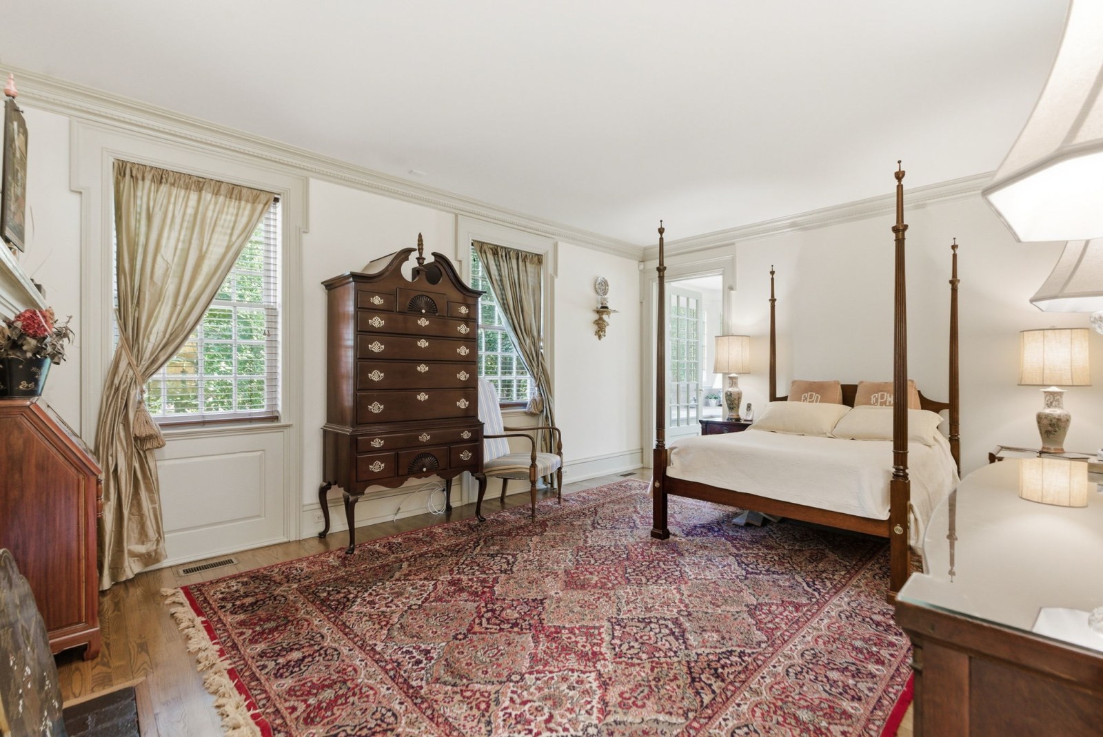 The primary suite, a private wing across the full depth of the home